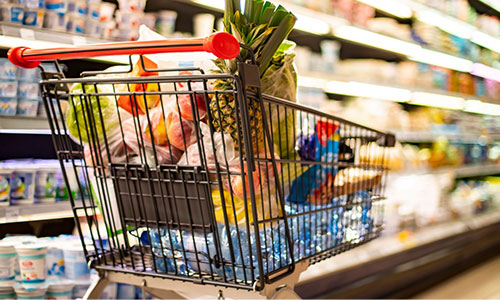 Shopping cart full of food in grocery store